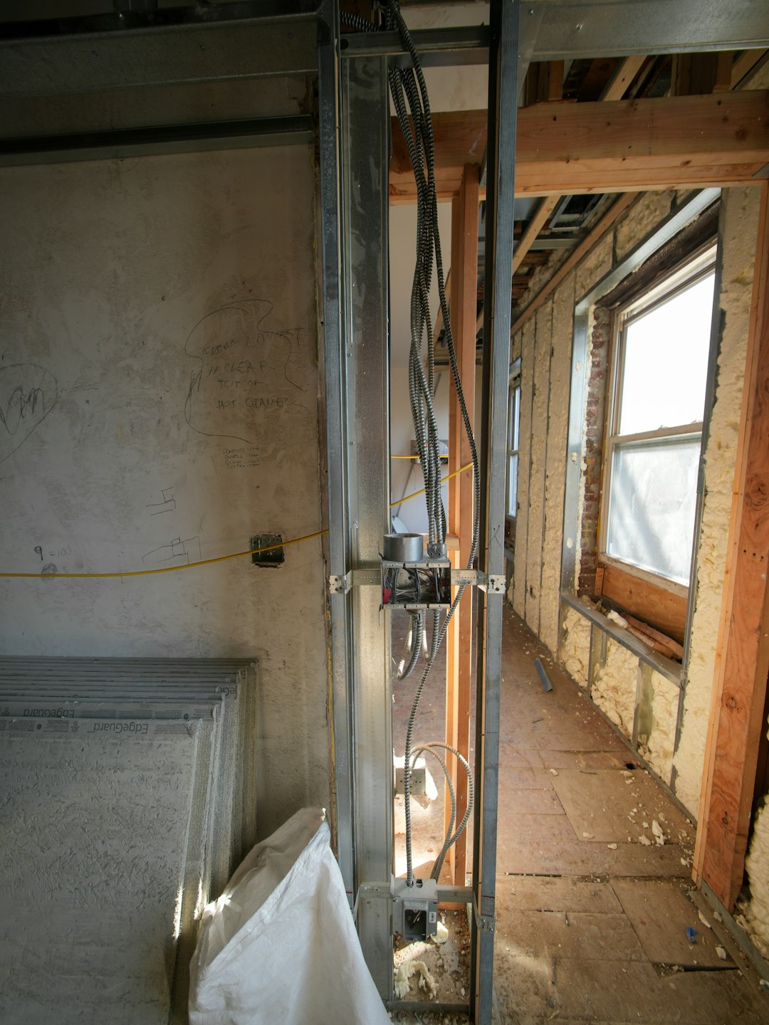 A three-story brownstone stands in mid-transformation, captured at the raw and honest “before” stage of a full interior renovation. These images document a moment that usually disappears once the walls are closed and the finishes are installed — exposed framing, stripped ceilings, rough staircases, and open corridors that reveal the building’s original structure and hidden history. Light spills in through skylights and tall windows, cutting through layers of dust and unfinished surfaces, creating a quiet contrast between decay and renewal. The space feels both industrial and intimate: narrow